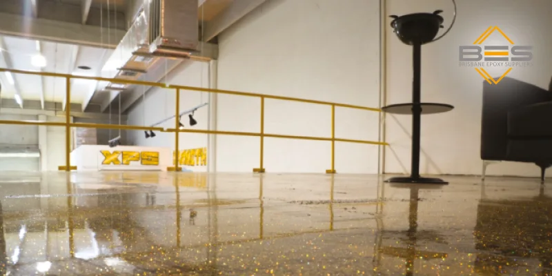  A side-by-side comparison image. Left side shows a plain, solid-color epoxy floor. Right side shows a vibrant epoxy flake floor in the same setting (e.g., half of a garage done each way).